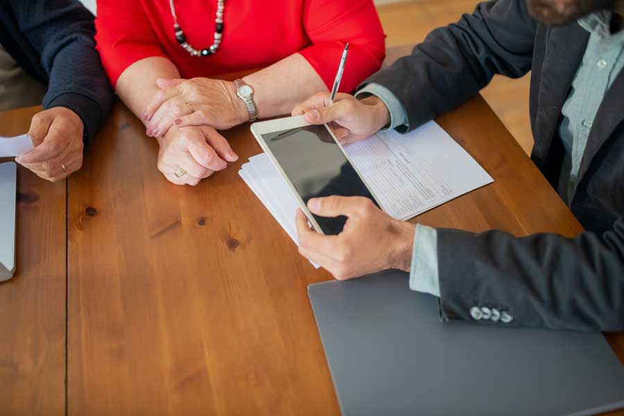 Volunteer helping elderly couple file taxes