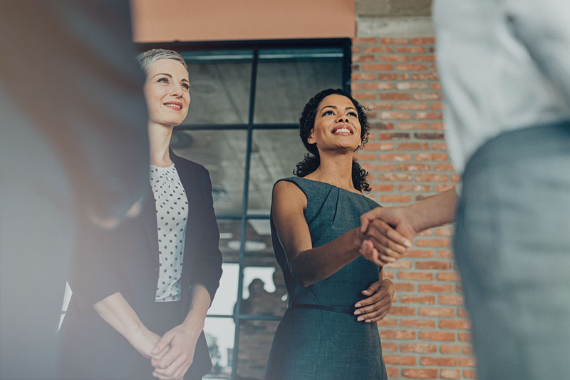 Women networking and shaking hands