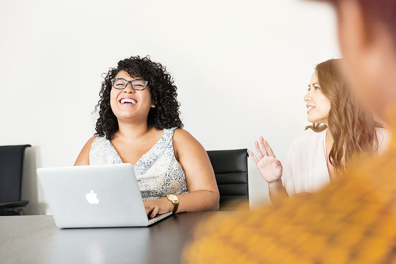 Young happy woman working with team