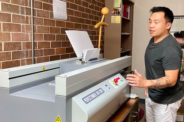 Male student works with printing press