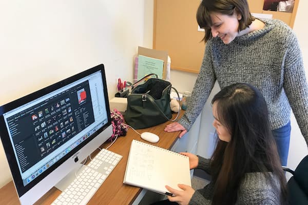 Two female students work on writing project together