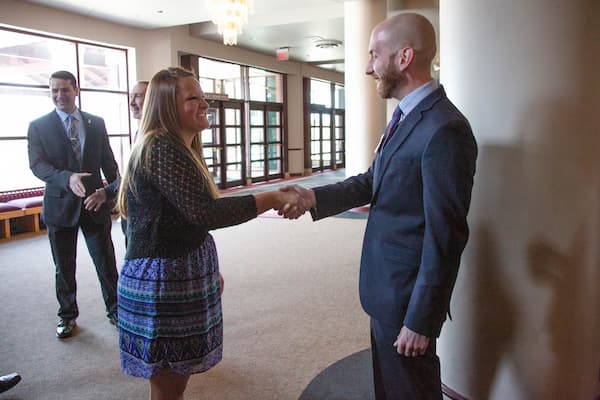 Female student shakes hands with local accountant during a UWGB networking event