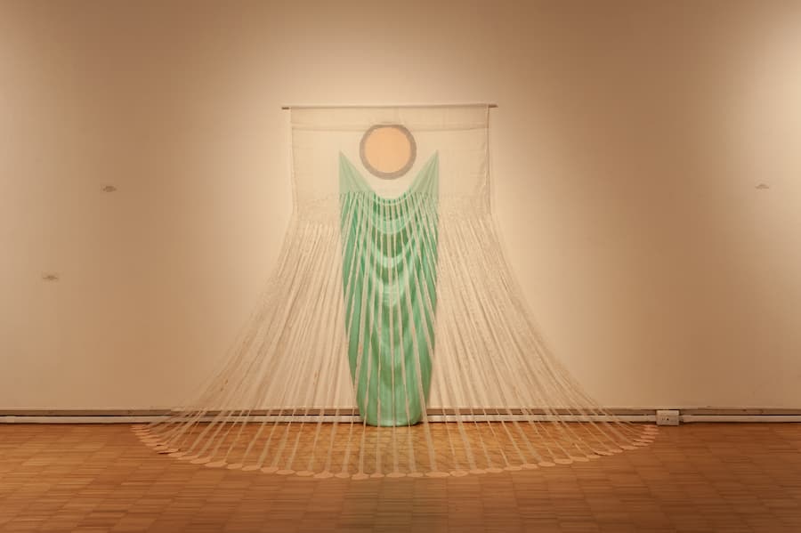 Student's fiber art dress is displayed in the Lawton Gallery