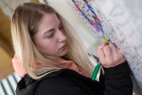 Group of students engage in outdoor drawing lesson