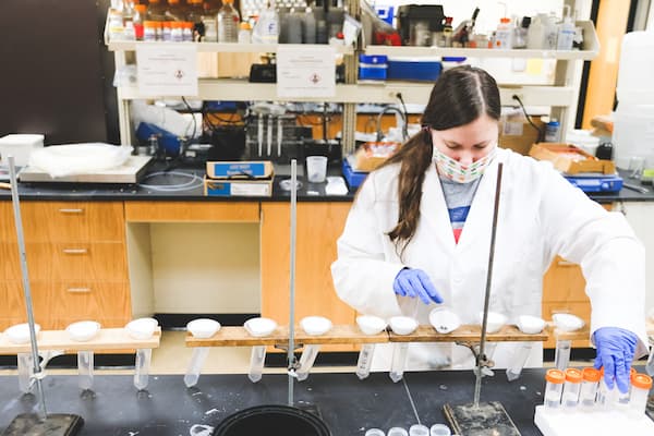 Student performs experiment in lab