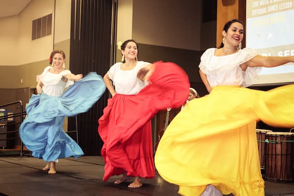Three female latin dancers preform.