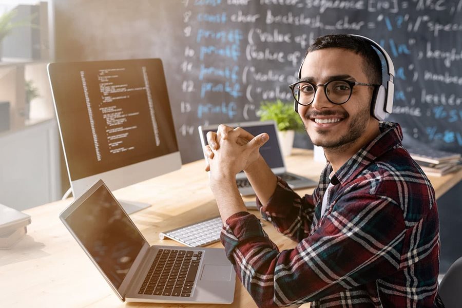 hispanic male smile at a computer