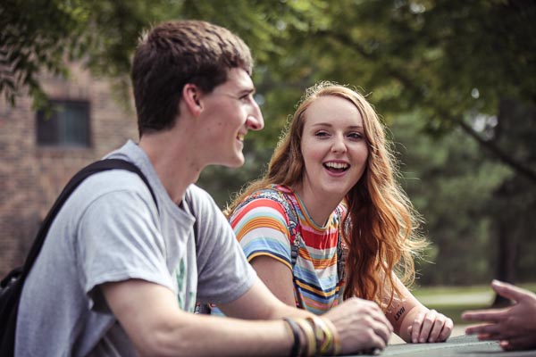 Students on a picnic outside at of a UW-Green Bay housing building