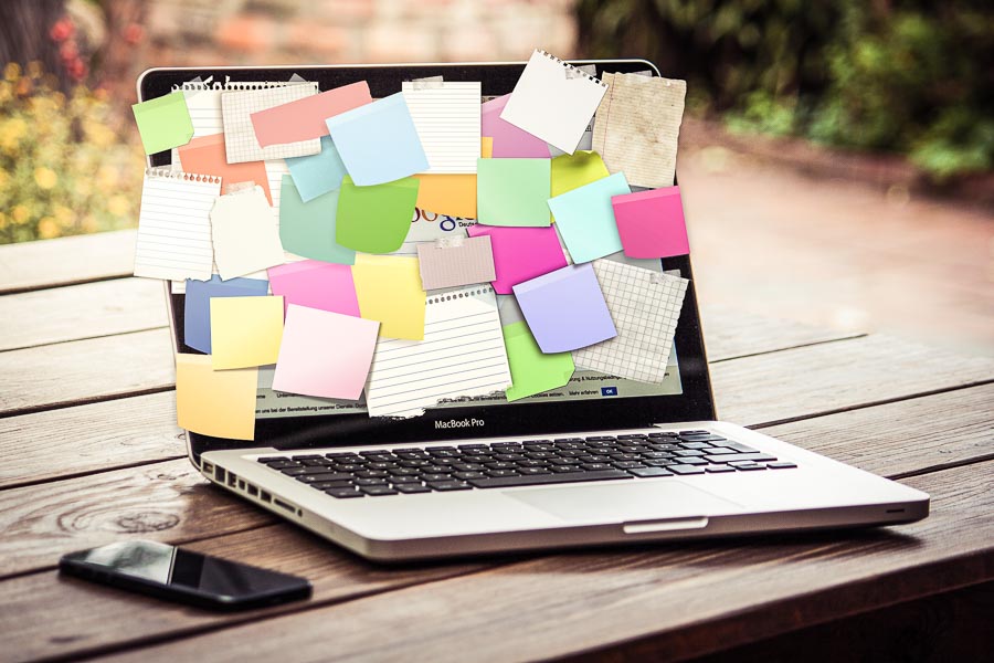 Laptop covered in notes