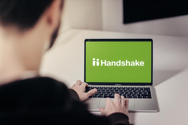 Student using a laptop to log into Handshake