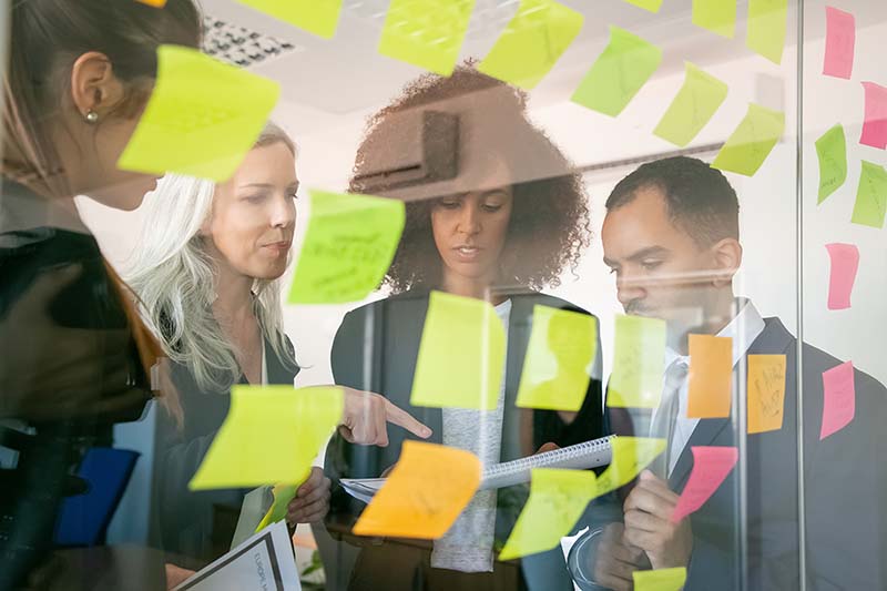 focused businesspeople reading documents while brainstorming