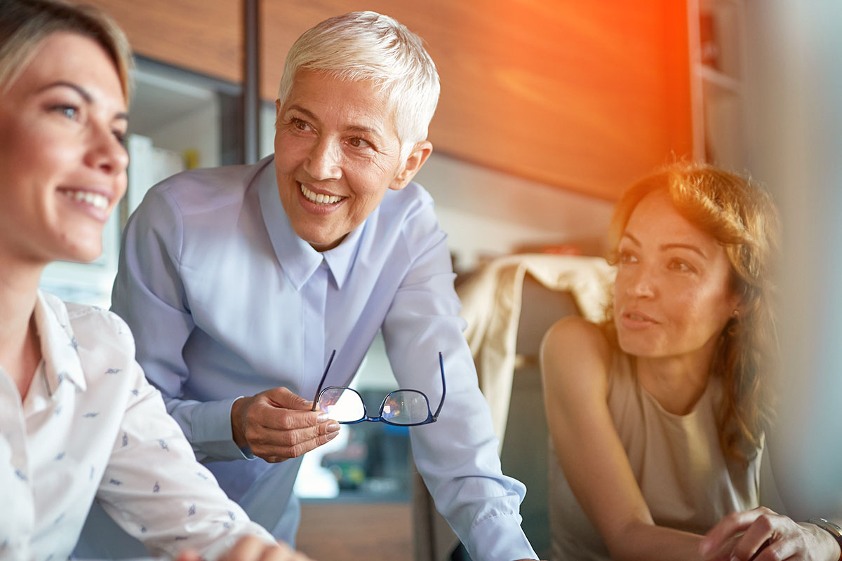 Senior colleague mentoring two workers