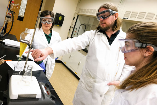 Students work with professor in Biochemistry Lab