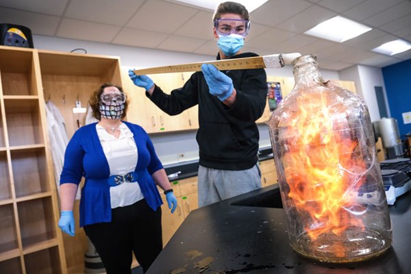 Manitowoc student and professor perform experiment with fire