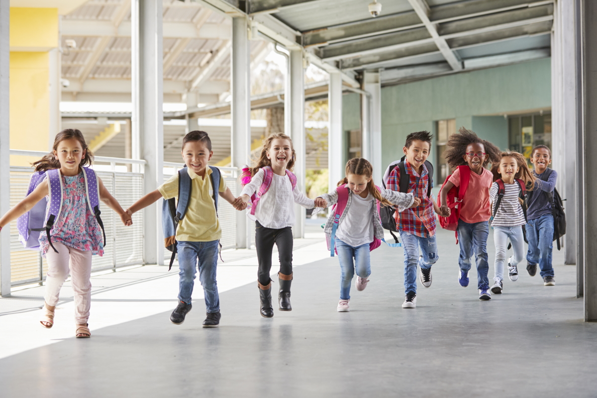 Kids holding hands and running in a line