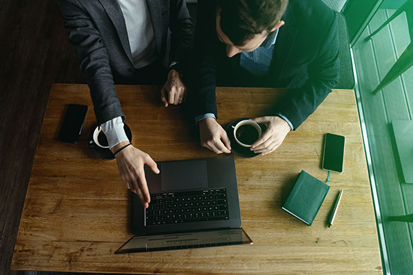 Mentor pointing at laptop screen