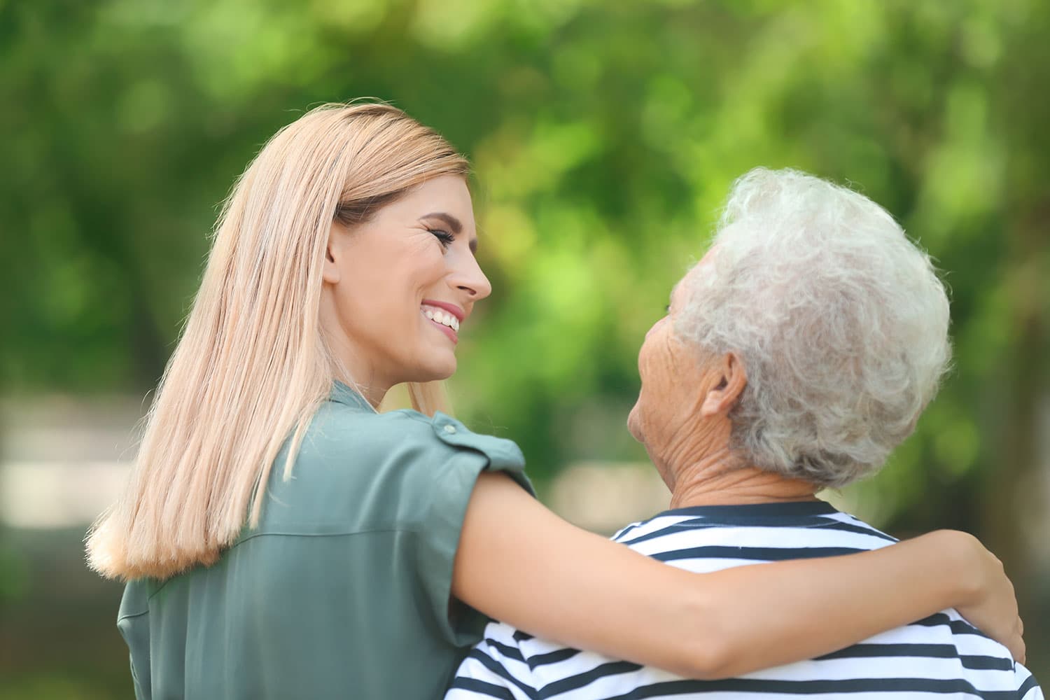 Caregiver helping elderly woman