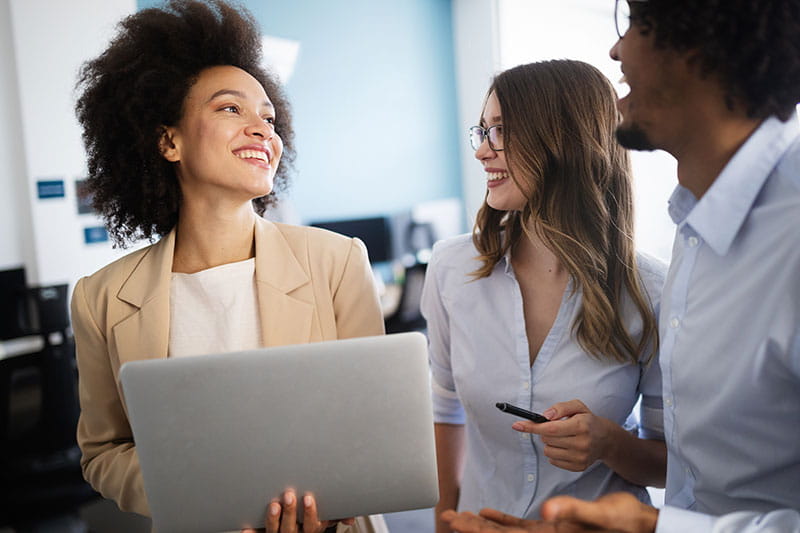 Confident woman talking with coworkers