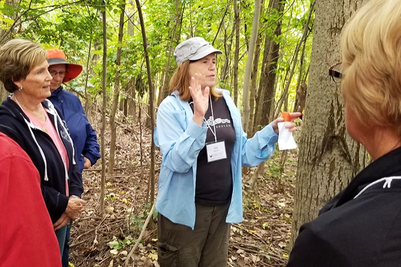 woman leading class in woods