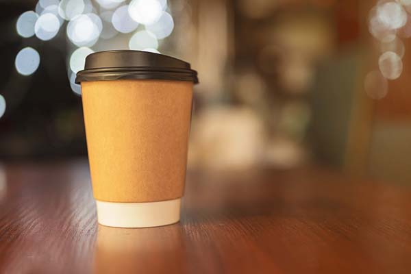 to go cup of coffee sitting on table