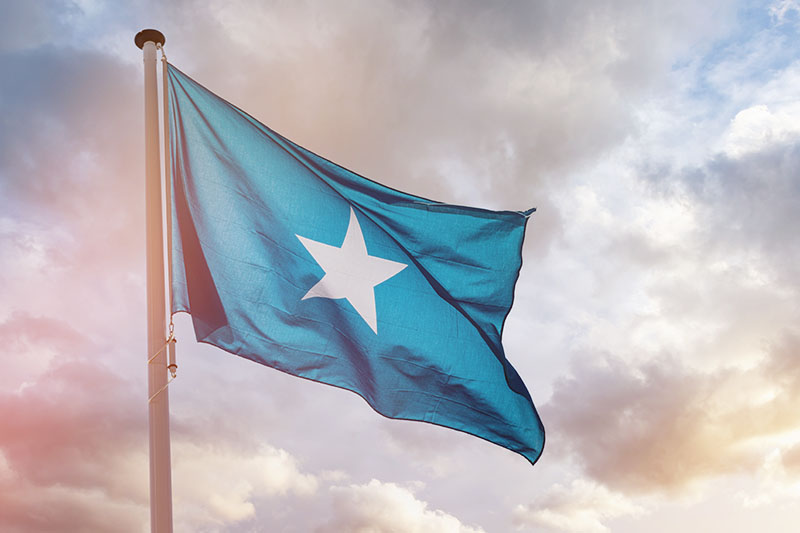 Somali flag blue with white star waving in cloudy sky