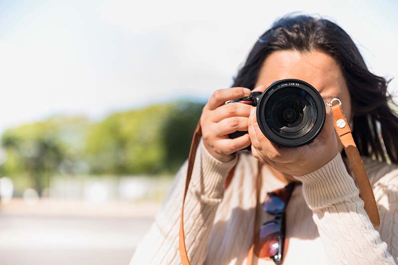 woman taking a photo while traveling