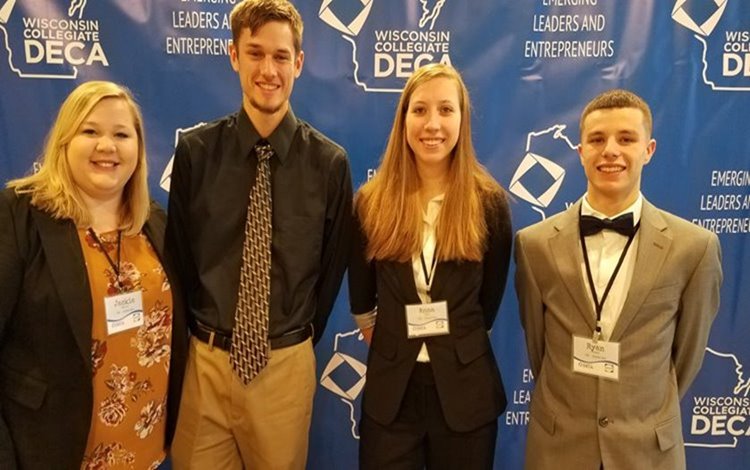 Four people standing together for DECA