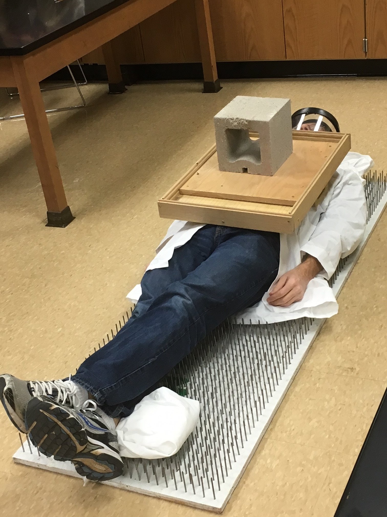 Physics experiment - laying on a bed of nails