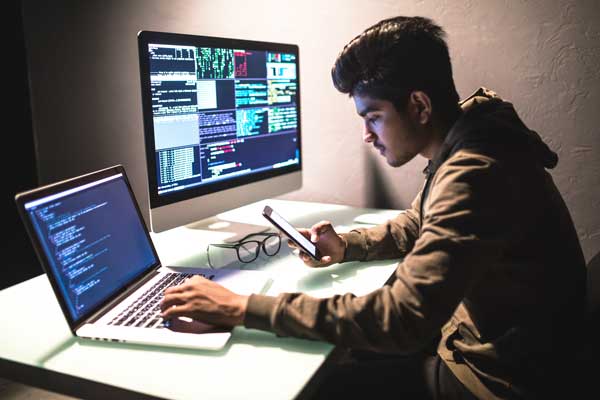 Student works on dual monitors