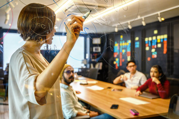 Female presents data during meeting