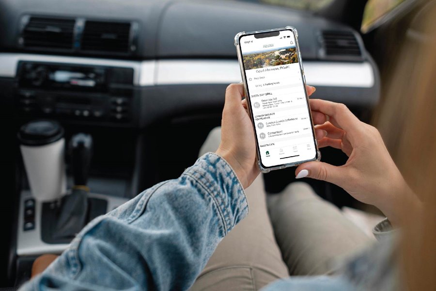 Student sitting in their car browsing the UWGB Dining App