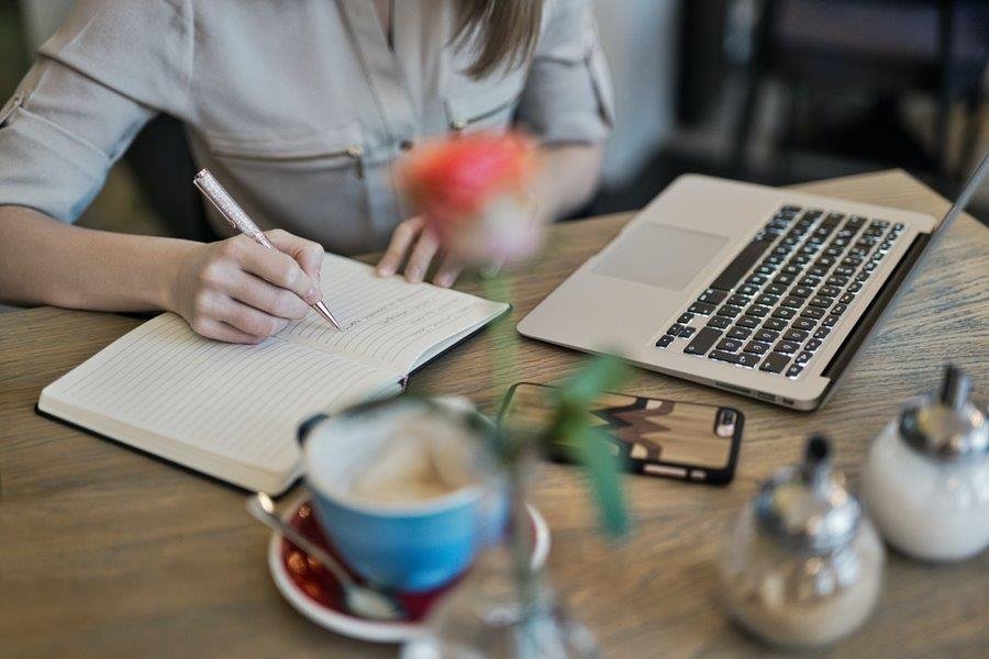 Writer sitting by a desk working