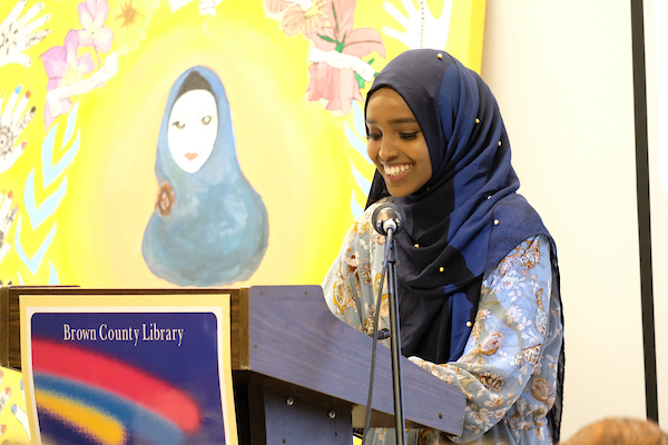 Woman in Hijab presents project