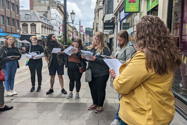 Group of students look at maps while in Whales