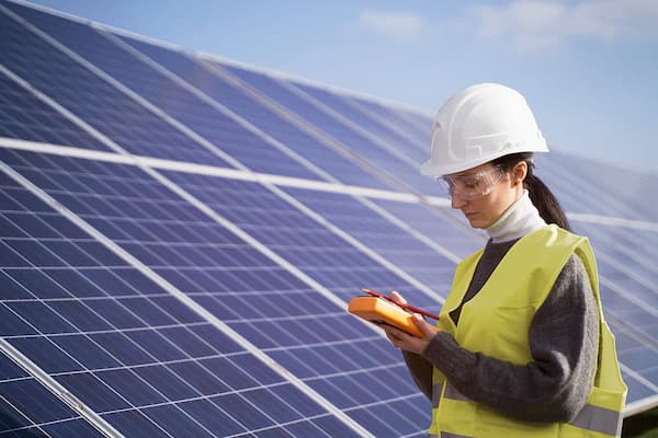 Female works with solar panels