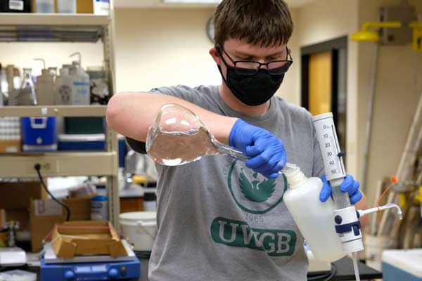 Student studys water filters in lab