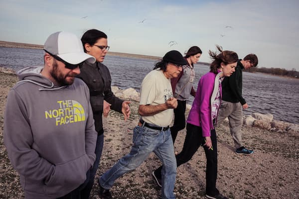 Marcello Cruz and students walking near waterfront area in Green Bay, WI