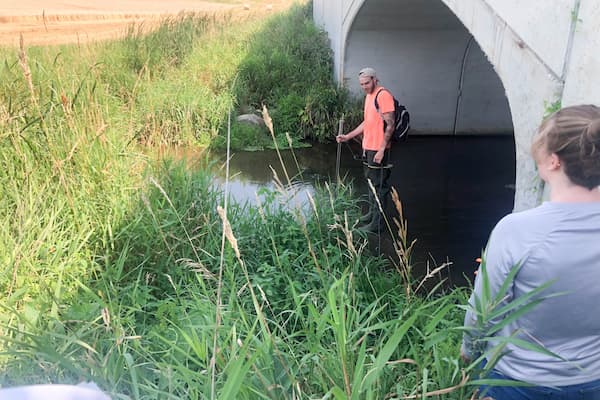 Student studys water under bridge