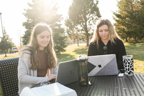 Two students study outdoors
