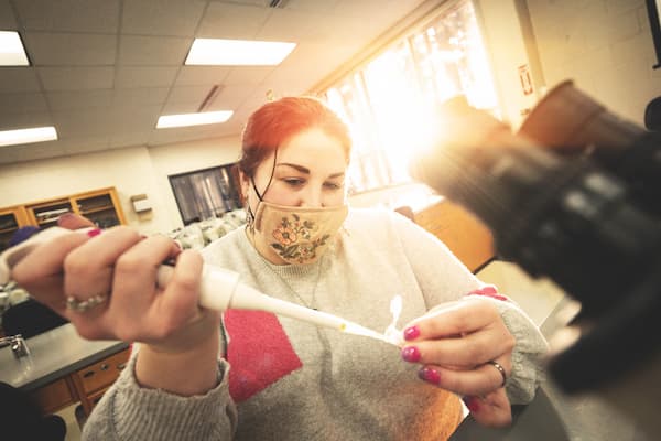 Student tests water sample in research lab