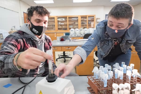 Professor helps student perform water testing