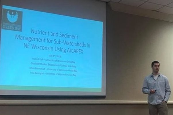 Student presenting on his thesis at a conference.