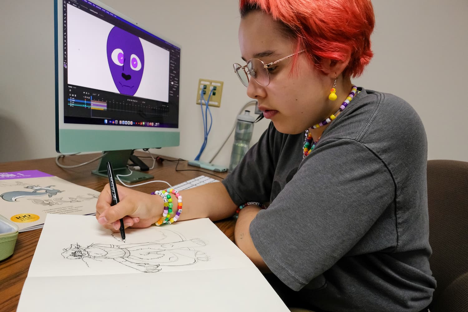Person drawing a comic sketch