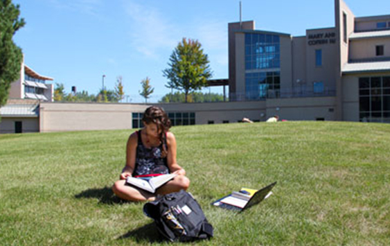 Student studying on the quad