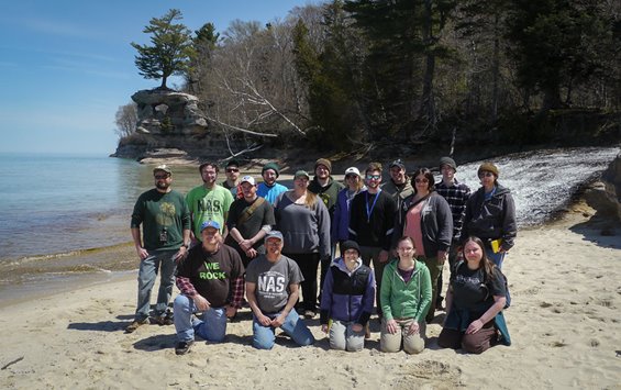 Geology club members posing on a beach
