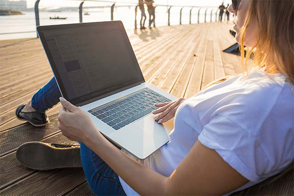 A UW-Green Bay student attends class outside doing field work.