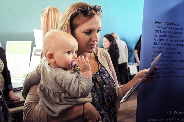 Woman attending the UWGB Social Work Symposium holding an infant.
