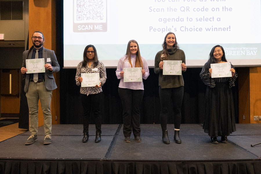 Winners of the Three Minute Thesis pose with awards