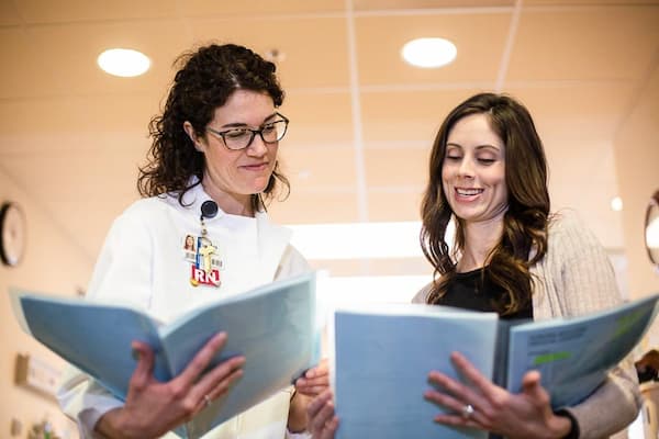 Two nurses looking over clinical charts