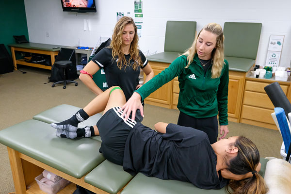 Master's of Althetic Trainging students work on UW-Green Bay Athlete